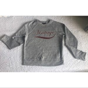A cozy sweatshirt with the word vintage on it